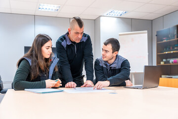 Engineers during a meeting in a factory meeting room