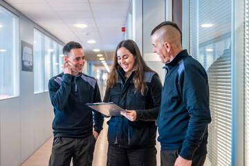 Workers of a logistic factory talking in a corridor