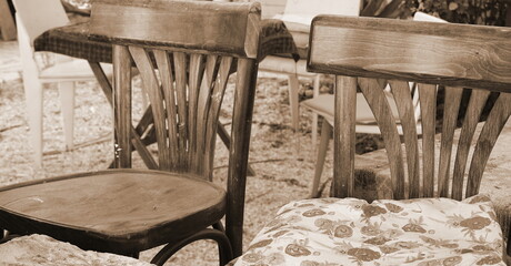 Vintage Chairs and a Pillow. Retro Wooden Furniture. Floral Pattern. Outdoor. Sepia Style