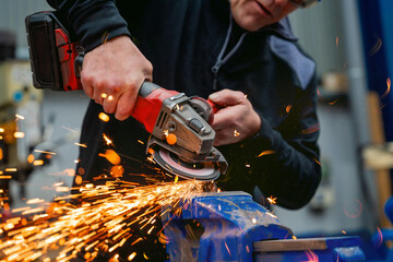 Close-up of a worker using an electric wheel grinding