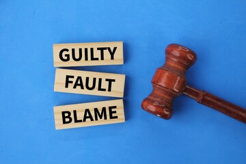 judge gavel and stick with the word Guilty Fault Blame. the concept of guilt or blame - obrazy, fototapety, plakaty