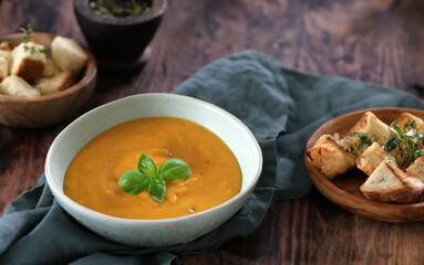pumpkin cream soup with croutons in a bowl