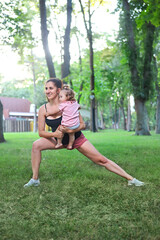 Woman exercising with her baby girl in the park