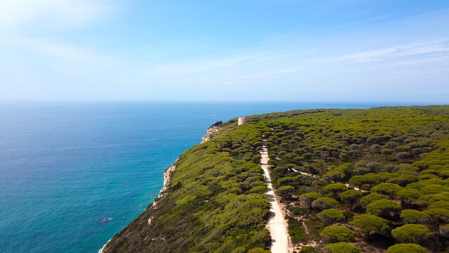 aerial view of the Atlantic Ocean and the Parque Natural de la Bre&ntilde;a y Marismas de Barbate nature reserve with the Torre del Tajo historical watchtower, Costa de la Luz, Spain