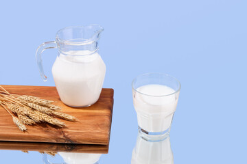 Good nutrition. Fresh and white milk, wheat and wooden board. Copy space for text.