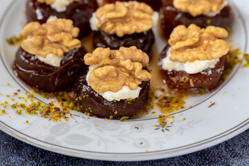 Traditional stuffed dried fig dessert with walnuts and cream, cooked with syrup (Turkish name: fig dessert with cream).​