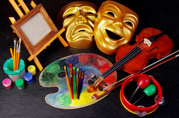 Attributes of the arts. Painting, music, theater. Canvas, palette, brushes, paints. Violin, bow,...