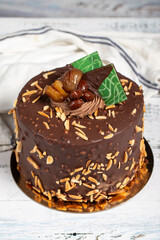 Pistachio birthday cake. Chocolate and pistachio cake on a white background