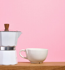 Italian metallic coffee maker and cup of hot coffee. Copy space for text.