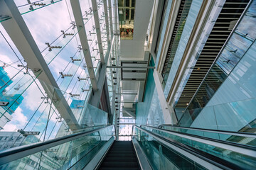Upward view of electric escalators inside high-end shopping malls..