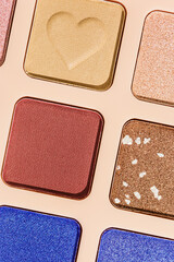 Vivid colored eye shadow makeup palette close up, colorful swatches cosmetic and beauty product, shiny eye shadow in beige package, aesthetic background textures powder for eye cosmetics