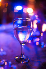 Wineglass outdoors on table by night