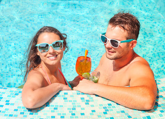 Young couple are relaxing in swimming pool