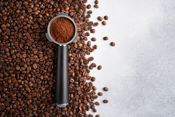 Portafilter with a ground coffee and roasted coffee beans