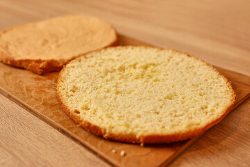 A freshly baked cake is cut in half. Cooking a festive pie at home