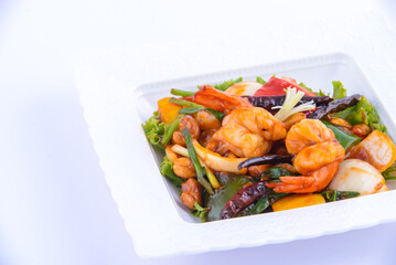 Sweet and sour shimp stir fried on the white dish.
