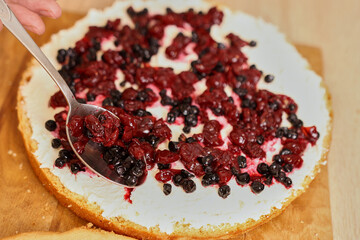 Adding the filling to the cake. Cooking a festive pie at home