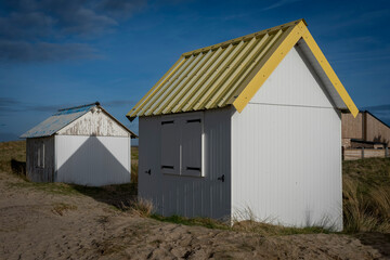 Gouville, France - 12 30 2023: View of colorful bathing wooden cabins of Gouville on the dunes.
