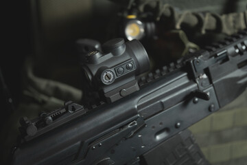 A modern red dot sight is installed on an AK 12, close-up photo.