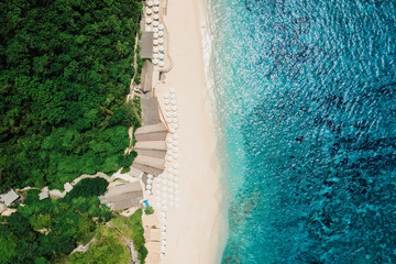Paradise beach with turquoise ocean and resort in Bali. Aerial view