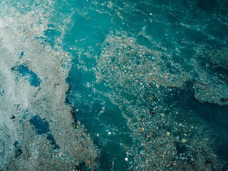 Indian ocean and plastic trash, aerial view. Pollution by rubbish in Indonesia
