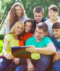 Fototapeta na wymiar Young college students using tablet computer