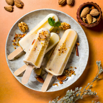 Malai kulfi traditional Indian ice scream or Qulfi, Rajasthani home made ready to eat frozen dairy dessert. rajwari or rajwadi sweet kesar badam pista ice cream candy.