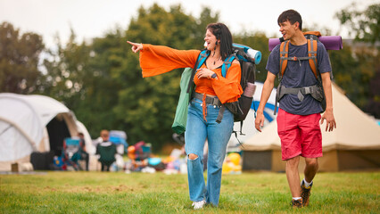 Young Couple Meeting At Summer Music Festival With Camping Equipment