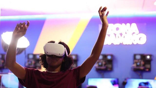 African American girl playing with virtual reality glasses touching and pointing with fingers