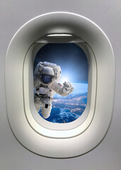 Astronaut in outer space from porthole. Elements of this image furnished by NASA.