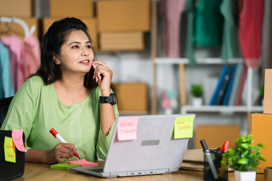 Indian small businesswoman office busy planning business or sales growth at ecommerce warehouse - concept of brainstorming, workplace strategy and productivity