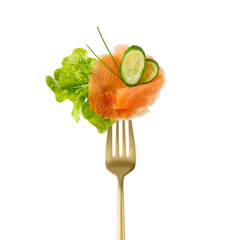 Salted smoked red salmon fish slice, fresh lettuce salad leaf, cucumber pieces and herbs on golden...