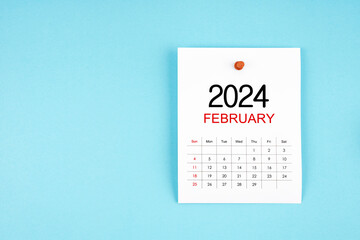 February 2024 calendar page with push pin on blue background.