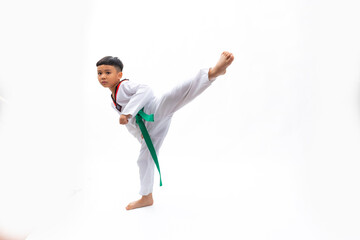Practice side Kick. kids karate martial arts. Taekwondo uniform with green belt. Portrait Thai Asian school boy isolated on white background banner. Action sport training concept