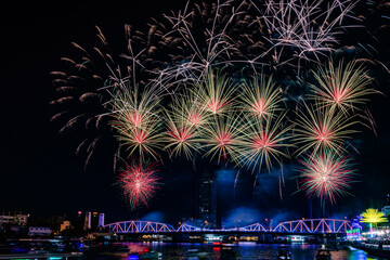 Firework show along Chao Praya River in Bangkok city, Thailand during the new year of 2024 to come.