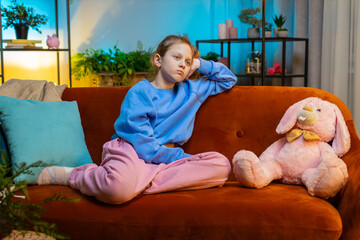Sad lonely redhead child girl at home looks pensive thinks over life concerns or study test exam...