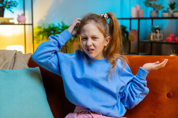 What. Why. Caucasian child girl raising hands in indignant expression, asking reason of failure...