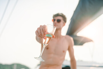 Caucasian man hand holding champagne glass relax and enjoy luxury outdoor lifestyle while travel on...
