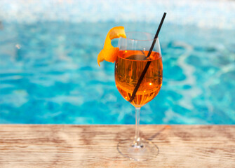 Glass of Aperol Spritz cocktail by the pool