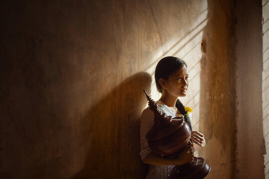 Myanmar girl with basket on  background, Myanmar woman concept