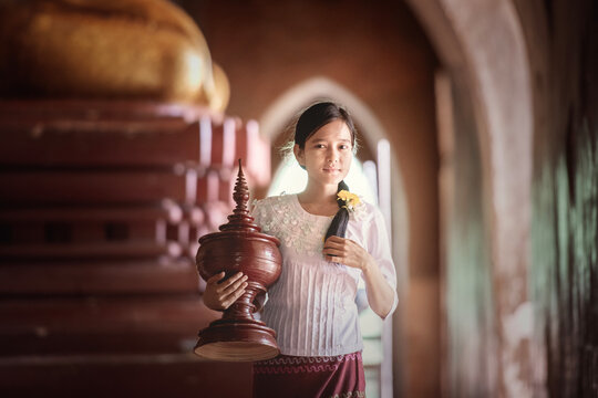 Myanmar girl with basket on pink background, Myanmar woman concept