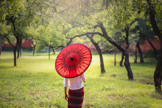 Portrait young Burmese girl posing with umbrella in Bagan