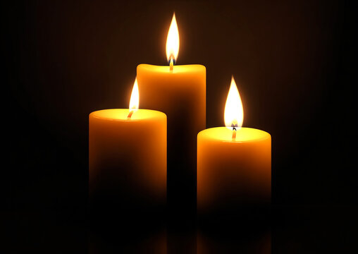 3 burning candles on abstract black background