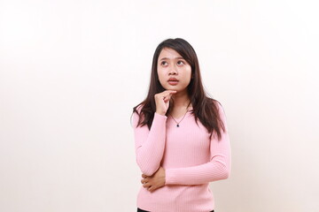 Thoughtful young asian girl standing while thinking and imagining an idea. Isolated on white background