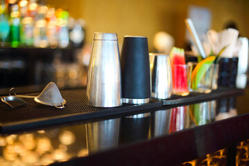 Bar counter with bottles in blurred background