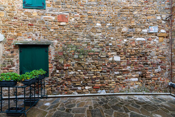 Grado, Italy - January 01th, 2024: Wall of a house in the historic part with bricks of various colors. Ancient walls with typical textures. Facade positioned in the "Androna Della Chiesa".