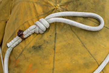 Close-up of a rope with a knot for quick attachment on the port of Grado, Italy. Items for fishing...