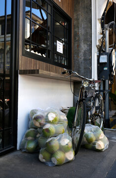 hailand, bicycle and bags of coconuts