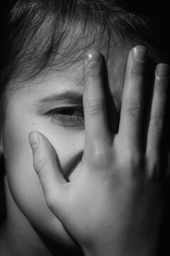Crying depressed young girl. Portrait. Loneliness, pain, child tragedy. Black and white image.