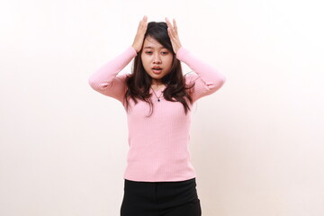 Obraz na płótnie Canvas Tired Stressed frustrated young asian girl standing while holding head. Isolated on white background
